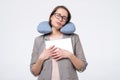 Caucasian matur woman in glasses resting with travel pillow in vacation trip Royalty Free Stock Photo