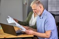 caucasian mature couple checking bills while managing accounts on home banking app Royalty Free Stock Photo