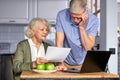 caucasian mature couple checking bills while managing accounts on home banking app Royalty Free Stock Photo