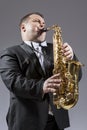 Caucasian Mature Expressive Saxophone Player Playing the Instrument