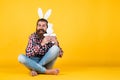 Caucasian mature hipster in buny ears with trendy hairstyle in checkered shirt celebrate easter, copy space, easter joy