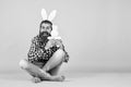 Caucasian mature hipster in buny ears with trendy hairstyle in checkered shirt celebrate easter, copy space, easter joy