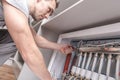 Men Adjusting Apartment Heat on the Central System Valves