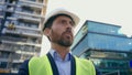 Caucasian middle-aged man adult male contractor wearing helmet and reflective vest architect pensive thinking in city Royalty Free Stock Photo