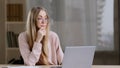 Caucasian millennial business woman female student girl writer journalist wearing glasses sitting at table at office