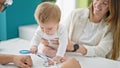 Caucasian mother with baby on a doctor appointment at clinic Royalty Free Stock Photo