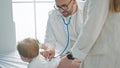 Caucasian mother with baby on a doctor appointment at clinic Royalty Free Stock Photo