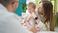 Caucasian mother with baby on a doctor appointment at clinic Royalty Free Stock Photo