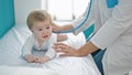 Caucasian mother with baby on a doctor appointment at clinic Royalty Free Stock Photo