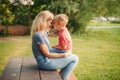 Caucasian mother and boy toddler son sitting together face to face and talking to each other Royalty Free Stock Photo
