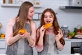 Caucasian mother with her daughter help to cook bakery together in kitchen and look happy with show to camera