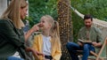 Caucasian mother talking laughing with funny daughter touching baby nose small kid girl running hugging dad by neck Royalty Free Stock Photo