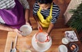 Caucasian mother teaching her son how to cook preparing the ingredients to make a cake