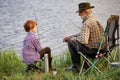 Caucasian multi-generation family fishing together. Boy with grandfather fishing outdoor Royalty Free Stock Photo