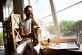 Caucasian musician playing saxophone during concert at home  and quarantined, impressive improvising with band Royalty Free Stock Photo