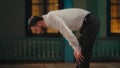 Side View of a Caucasian Muslim Man Bowing in Prayer in a Mosque at Night