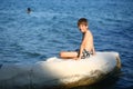 Caucasian nine year old boy sunbathing on the rock on the cyprus seashore