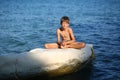 Caucasian nine year old boy sunbathing on the rock on the cyprus seashore