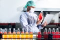 Caucasian Nutritionists man using computer notebook for checking the quality of herbal drinks