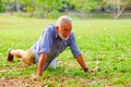caucasian old man doing push-ups in park Royalty Free Stock Photo