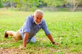 caucasian old man doing push-ups in park Royalty Free Stock Photo