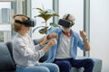 Caucasian old senior elderly grandparents couple wears virtual reality goggles headset. gray bearded and hair grandpa husband and Royalty Free Stock Photo