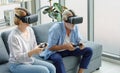 Caucasian old senior elderly grandparents couple wears virtual reality goggles headset. gray bearded and hair grandpa husband and Royalty Free Stock Photo