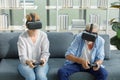 Caucasian old senior elderly grandparents couple wears virtual reality goggles headset. gray bearded and hair grandpa husband and Royalty Free Stock Photo