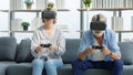 Caucasian old senior elderly grandparents couple wears virtual reality goggles headset. gray bearded and hair grandpa husband and Royalty Free Stock Photo