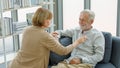 Caucasian old senior elderly supportive wife sitting use stethoscope testing listening heartbeat from unhealthy gray bearded and Royalty Free Stock Photo