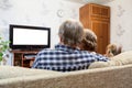 Caucasian parents and daughter sitting on couch and watching tv, isolated white screen