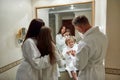 Beauty lies in a healthy mind, body, and spirit. Parents and two kids in white bathrobes having morning routine in hotel Royalty Free Stock Photo