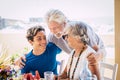 Caucasian people mixed ages and generations - grandfathers and grandson together family at the table eating food and enjoying