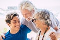 Caucasian people mixed ages and generations - grandfathers and grandson together family at the table eating food and enjoying Royalty Free Stock Photo