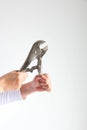 Two hands grasping a pincers pliers tightly on white background Royalty Free Stock Photo