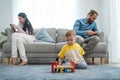 Caucasian phone addict parents don`t pay attention with baby toddler. Family problem, Father and Mother sit on sofa and using