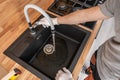 Caucasian Plumber Checking Kitchen Water Supply Royalty Free Stock Photo