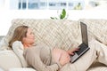 Caucasian pregnant woman working on a laptop