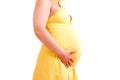 Caucasian pregnant woman in yellow dress isolated.