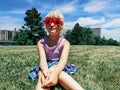 Caucasian preschool girl wearing funny Canadian maple leaves sunglasses celebrating Canada Day holiday outdoor.