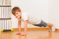 Caucasian preschooler boy making gymnastics