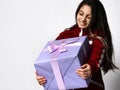 Caucasian preteen girl in tracksuit holding wrapped gift box portrait Royalty Free Stock Photo