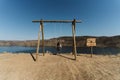 Caucasian female swinging on the sandy of Lagos do Sabor in Miradouro de Sao Lourenco, Portugal