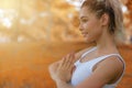 Caucasian pretty woman doing yoga and meditation in autumn background in park Royalty Free Stock Photo