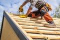 Roofing Contractor Attaching Wooden Elements to the House Roof