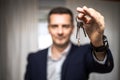 Caucasian real estate agent holding keys to the house in selective focus Royalty Free Stock Photo