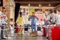 Caucasian redhead and afroamerican female colleagues are about to race in sacks at work. teambulding concept Royalty Free Stock Photo