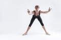 Caucasian Relaxed Ballerino Dancer Sitting While Practising Waist and Body Stretching Exercices With Lifted hands In Black