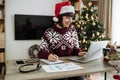 Caucasian remote employee starting day at home decorated with Christmas tree