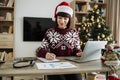 Caucasian remote employee starting day at home decorated with Christmas tree